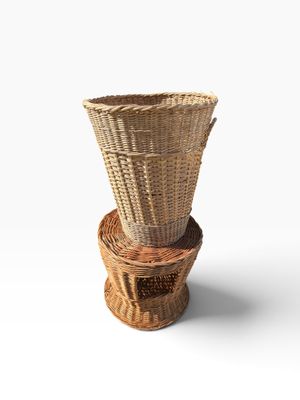 three wicker baskets stacked on top of each other on a white surface