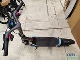 a scooter that is sitting on the ground next to a box