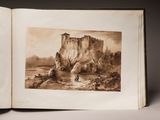 an open book with a drawing of a castle in the middle of it