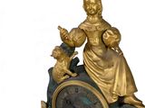 a statue of a woman sitting on top of a clock