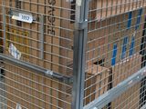 a metal cage with a bunch of boxes in it