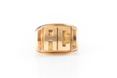 a close up of a gold ring on a white surface