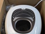 a white blow dryer sitting inside of a cardboard box