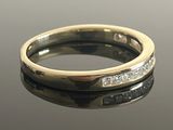 a close up of a diamond ring on a table