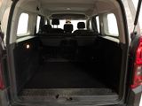 the back end of a van with the trunk open and the seats down