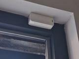 a window that has a small air conditioner on the side of it
