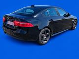 black car on a blue background with a blue sky in the background
