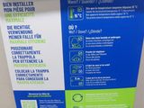 a white toilet with a blue and green sign on it