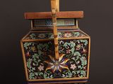 a small wooden box with a floral design on it