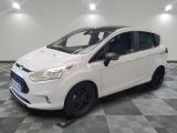 a white ford b - max parked on a checkered floor