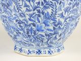 a blue and white vase with a flower design on it