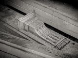 a black and white photo of a wooden bench