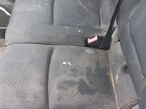 a dirty seat in the back of a car