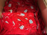 une boîte en carton remplie de sachets rouges contenant de la nourriture
