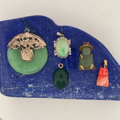 a lot of jewelry on a blue stone on a table