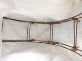 a metal bed with a white sheet covering it