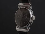 a close up of a watch on a black background
