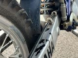 a close up view of a motorcycle tire with a chain on it