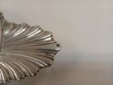 une assiette en argent ornée d'un motif de feuilles