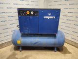 a blue compressor sits on a stand in front of a wall
