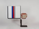 an image of a red, white, and blue object on a black stand