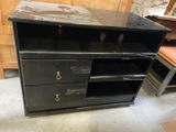 a black cabinet with three drawers and a shelf