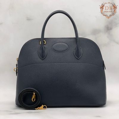 the navy blue leather handbag with gold hardware