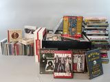 a lot of dvds and cds on the table