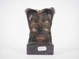 a bronze sculpture of a man ' s head on a marble base