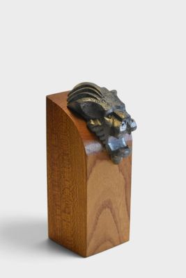 a wooden box with a statue of a dragon on top of it