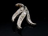 a close up of a diamond ring on a black surface