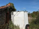 a white refrigerator sitting in the middle of a field