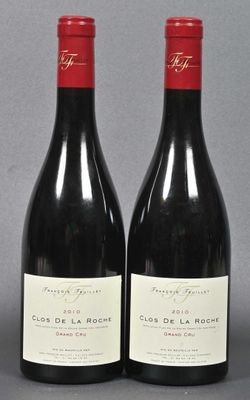 two bottles of red wine sitting next to each other on a table