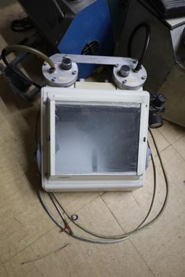a microwave sitting on the floor next to other appliances