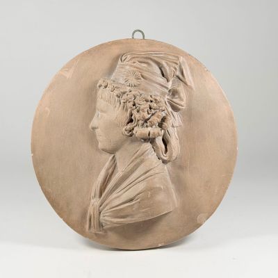a plaster plaque of a woman with a turban on her head