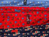 three ties are stacked on top of each other on a table