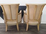 two wooden chairs sitting next to each other on top of a floor