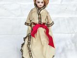a doll that is sitting on the ground in the snow