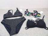 two pieces of underwear are laying on a bed next to each other