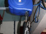 a picture of a water heater and a hose in a room