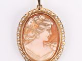 a gold and cameo cameo pendant with a woman ' s profile