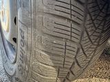 the tire of a car with a flat tire on a gravel road