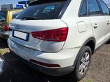 a white car parked in a parking lot with other cars