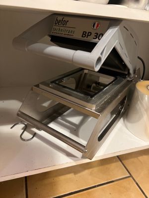 a toaster that is sitting on a shelf in a kitchen