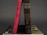 several books are stacked on top of each other on a table