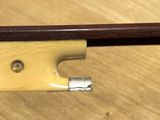 an image of a violin bow on a wooden table