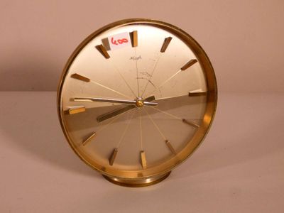 a gold clock that is sitting on a table