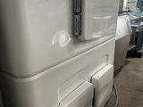 an image of a refrigerator in a warehouse with the door open