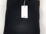 a black sweater with a tag on it