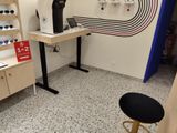 a desk with a computer on it in the corner of a room